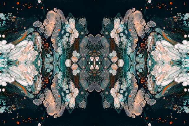 A symmetrical kaleidoscope pattern of a pineal gland features colorful abstract shapes and bubbles in dark tones.